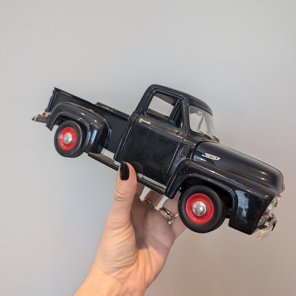 Classic Black Toy Truck with Red Wheels
